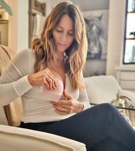 Woman using breastfeeding pump for engorgement treatment